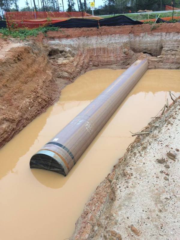 Red pipe in red clay wallow